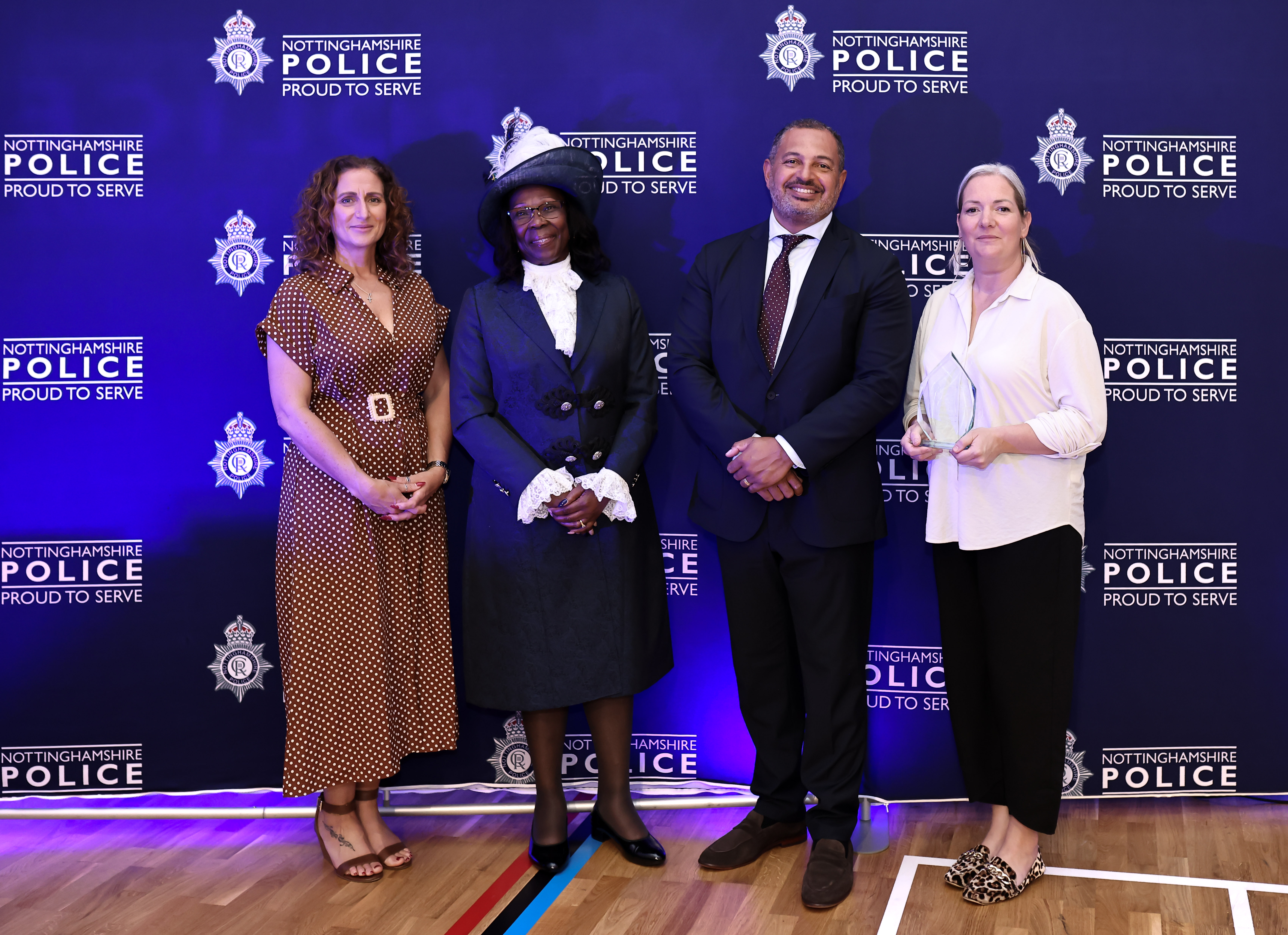PCC Gary Godden presenting the Vulnerability Award to representatives from Deaf-initely Women.