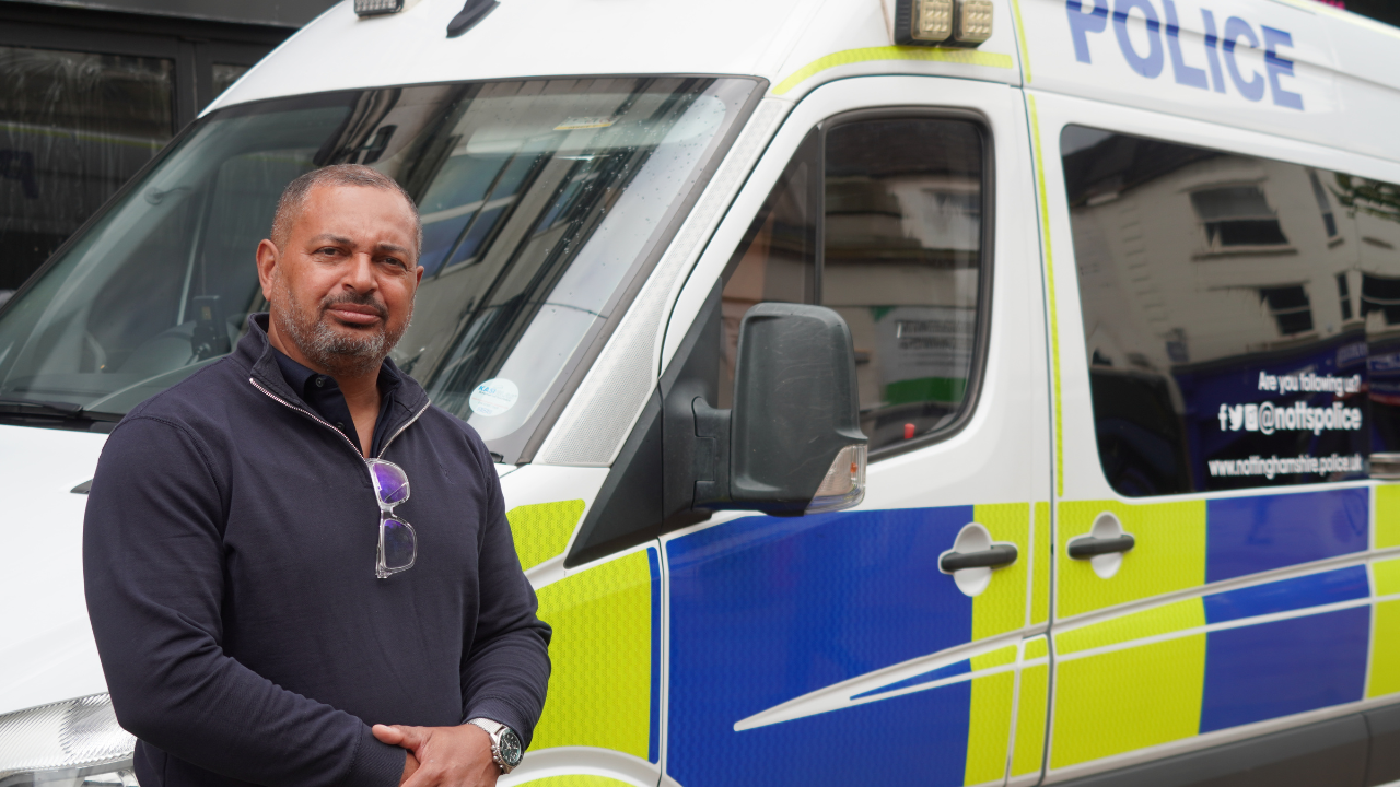 PCC Gary Godden standing next to a police van