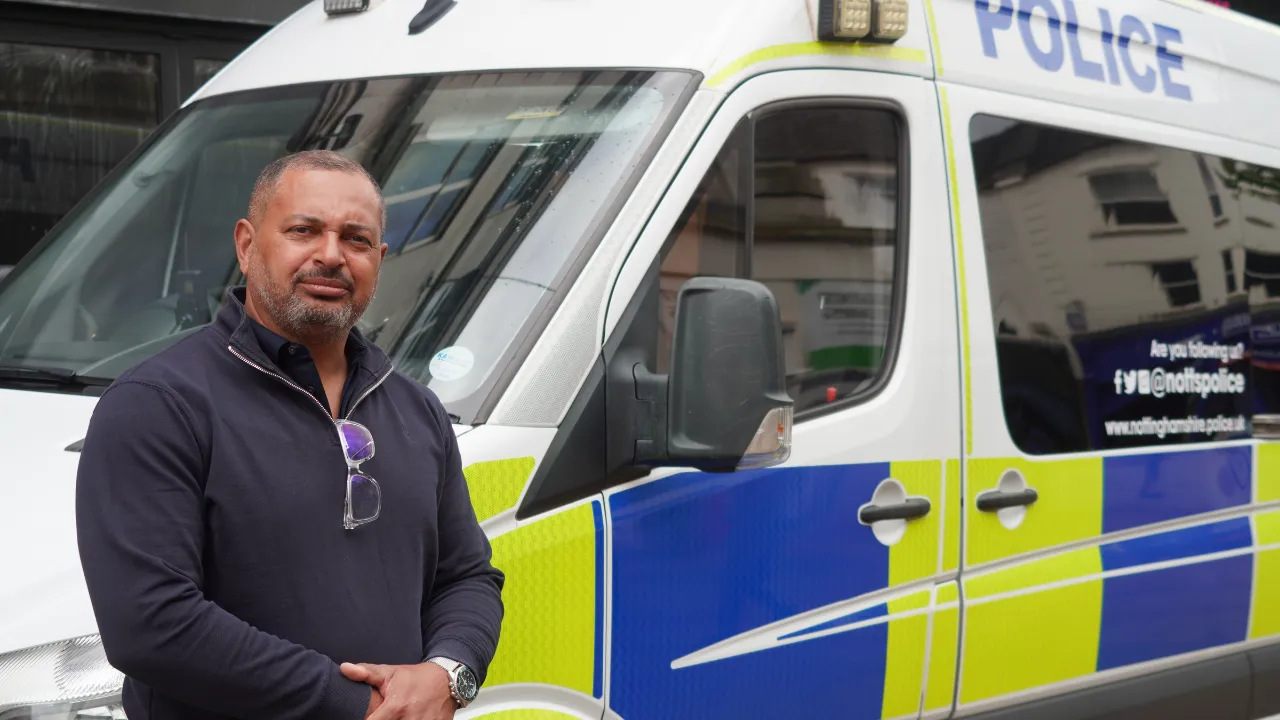 PCC Gary Godden standing next to a police van