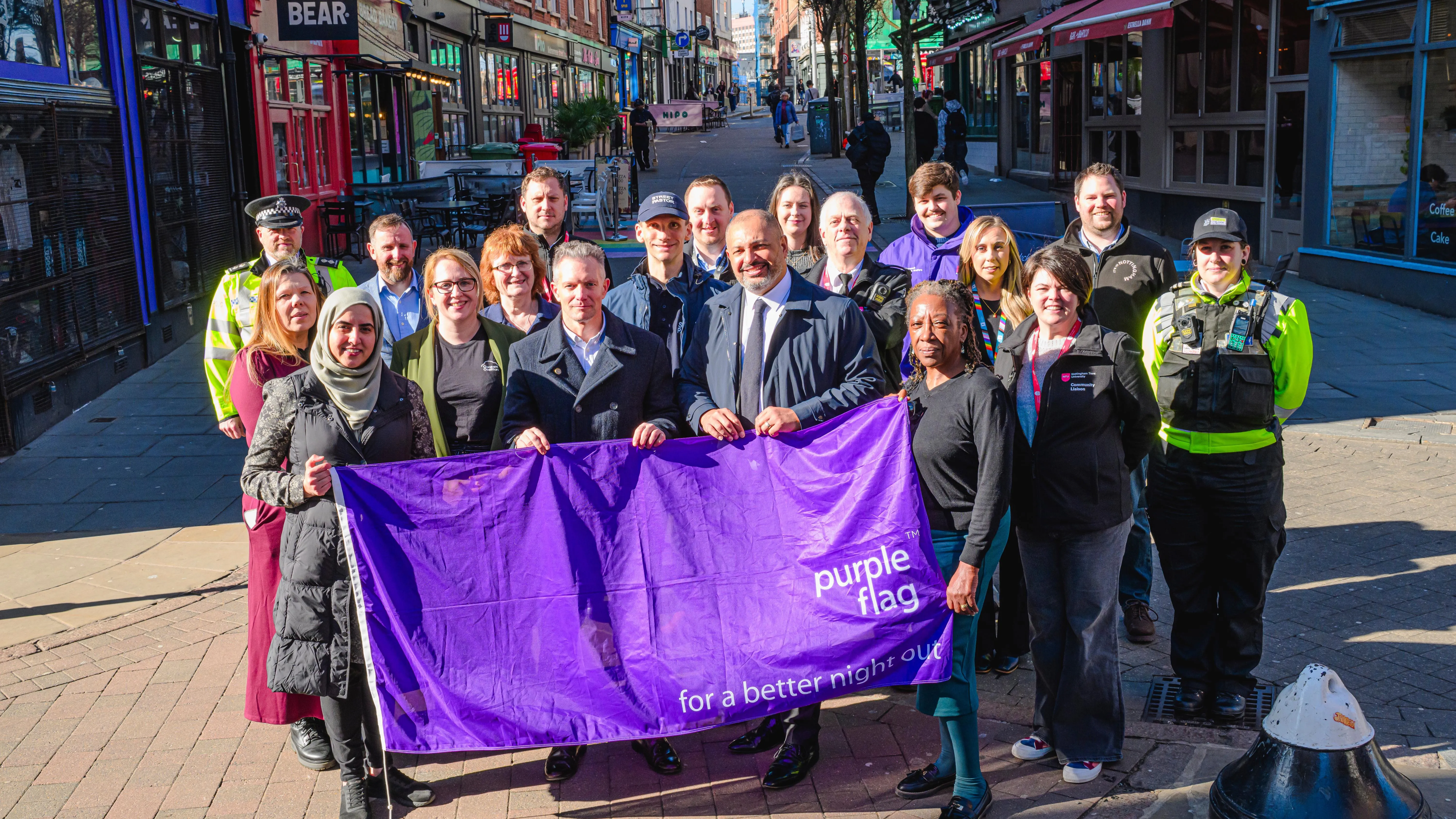 PCC Godden with partners holding a purple flag