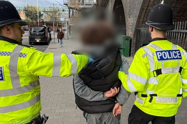 Police detain a suspect.