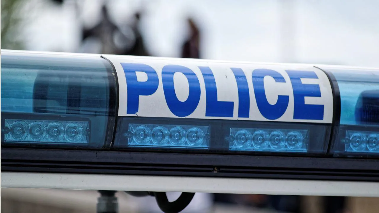 A Police sign on blue lights