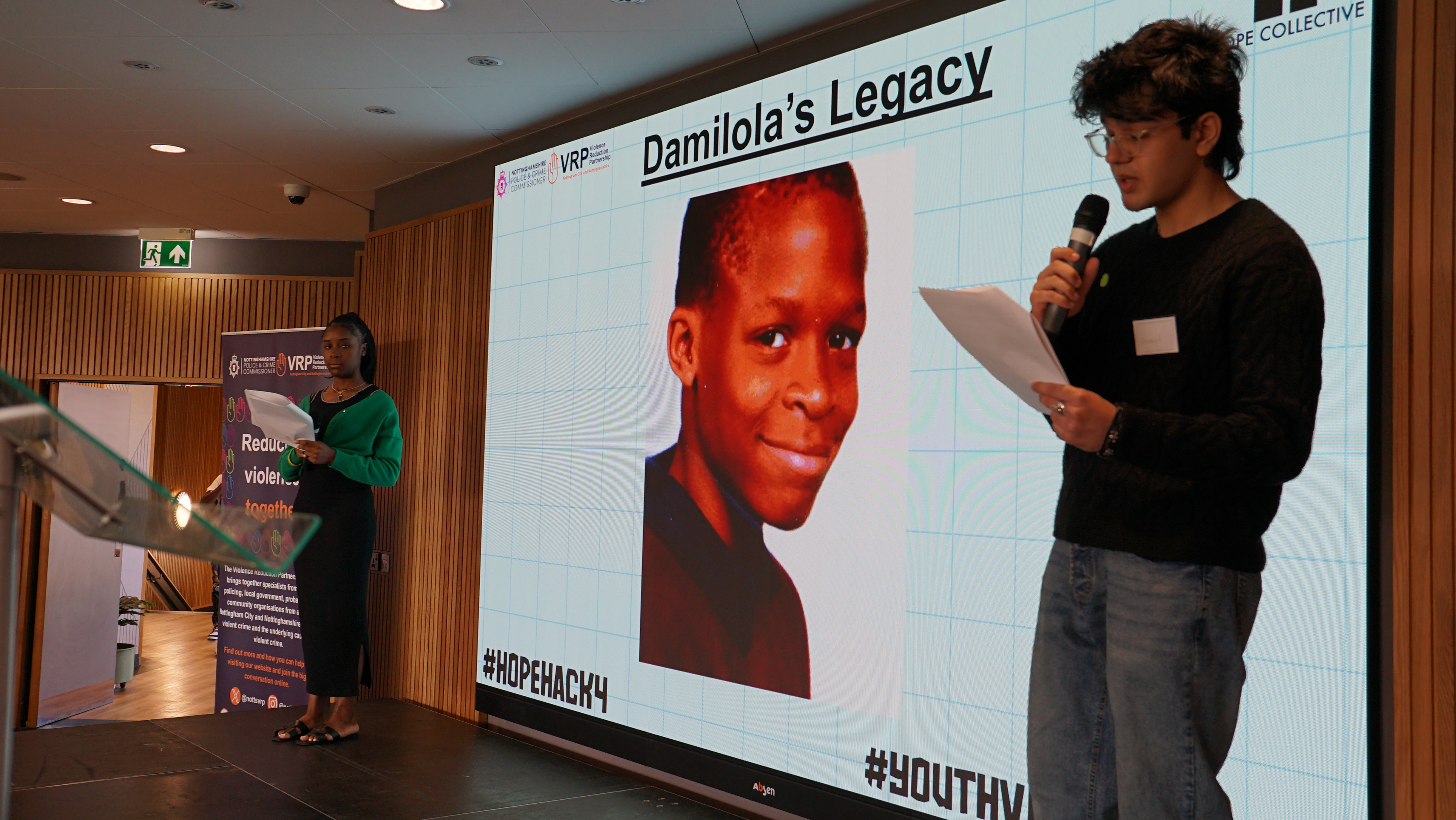 A stage presentation with a photo of Damilola Taylor in the background.