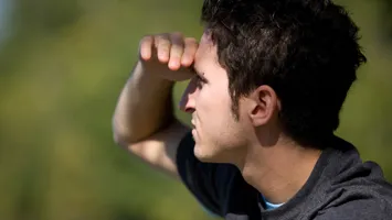 Image of a man looking into the distance