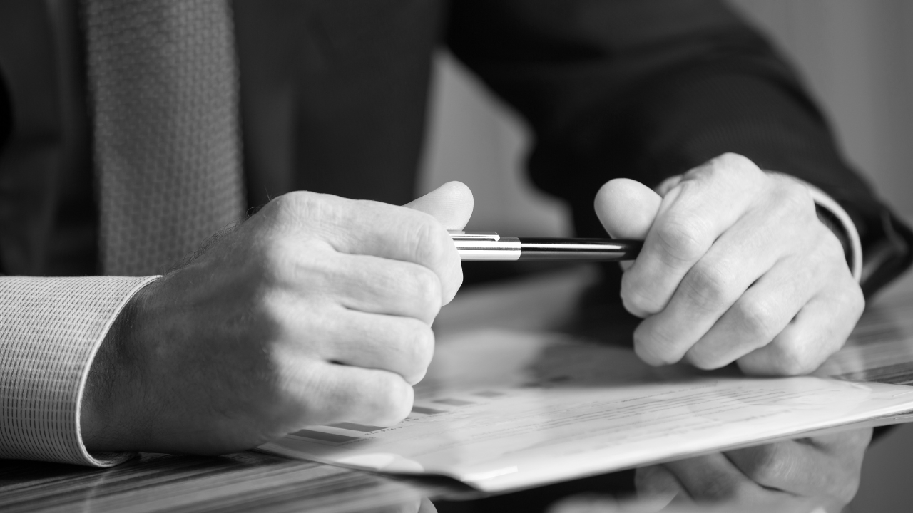 Man holding pen in office setting