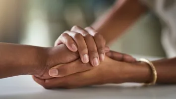 Generic image of two people holding hands to illustrate commissioned support services
